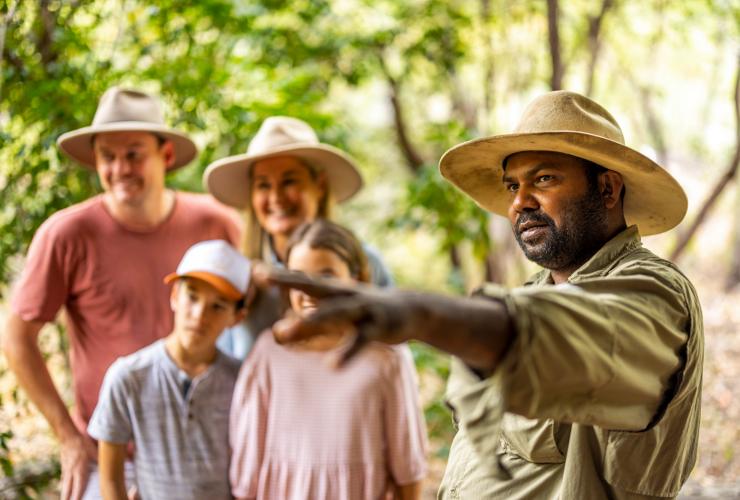 Culture Connect guide pointing as family listen in background, Tropical North Queensland © Tourism Australia Culture Connect guide pointing as family listen in background, Tropical North Queensland © Tourism Australia