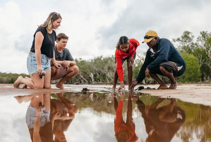 Indigenous tour guides and couple kneeling down to view a tidal pool, Southern Cross Cultural Walk, Cygnet, Western Australia © Tourism Australia Indigenous tour guides and couple kneeling down to view a tidal pool, Southern Cross Cultural Walk, Cygnet, Western Australia © Tourism Australia