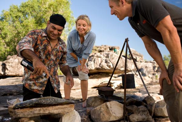 Mark Olive cooking a meal of fish for two guests, Davidson's Arnhemland Safaris, Northern Territory © Tourism Australia