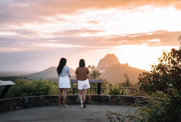Two friends admiring the sunset view of the Glass House Mountains, Sunshine Coast, Queensland © Tourism and Events Queensland